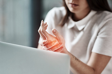 Image showing Laptop, pain in hand and woman in office with wrist injury from writing, typing and working on computer. Stress, medical care and girl worker touch hands with carpal tunnel, muscle ache and arthritis