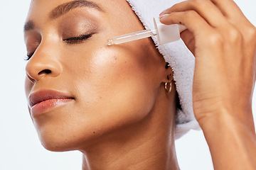 Image showing Black woman, beauty and face oil for skin in studio for dermatology, cosmetics and natural skincare. Aesthetic model with collagen spa facial serum and a healthy glow isolated on a white background