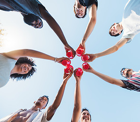 Image showing Cheers, sky and alcohol with a group of friends making a toast together at a party from below. Beer, freedom and drink with a man and woman friend group toasting outdoor during summer celebration