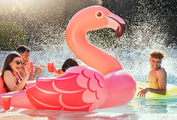 Image showing Pool, flamingo and friends at a party with drinks happy in the water with a splash outdoor. Swimming, alcohol and happiness of young people celebration in sunshine for summer together having fun