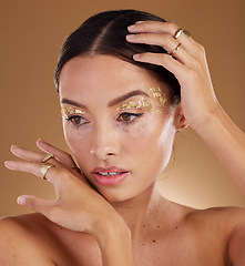 Image showing Skincare, glitter and woman with cosmetics, dermatology and girl on brown studio background. Makeup, female or lady with grooming routine, natural beauty or treatment for healthy, smooth or soft skin