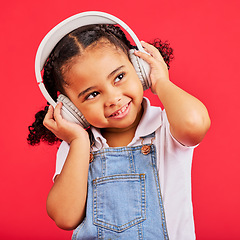 Image showing Happy, kid and headphones for music, radio and fun podcast on isolated red background and dancing studio. Smile, little girl and child listening to dance audio, sound and streaming media on backdrop