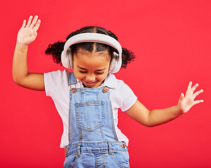 Image showing Dancing, energy and kid and music headphones, fun radio and loud podcast on isolated red background or studio backdrop. Smile, happy child and girl listening to dance audio, sound and streaming media