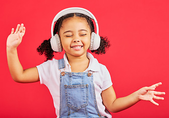 Image showing Dancing, energy and child on music headphones, fun radio or loud podcast on isolated red background or studio backdrop. Smile, happy kid and girl listening to dance audio, sound and streaming media