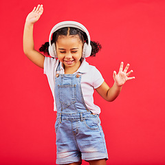 Image showing Dance, energy and happy child on music headphones, fun radio and dancing podcast on isolated red background. Smile, girl and dancer kid listening to audio, streaming sound and media on studio mockup