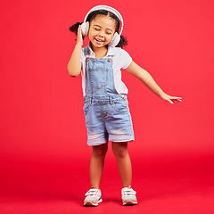 Image showing Dancing, energy or little girl on music headphones, fun radio or childrem podcast on isolated red background. Smile, happy or dancer kid listening to audio, sound and streaming media on studio mockup