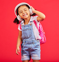 Image showing Student, child or headphones for music, school podcast or education radio in nursery song, sound or learning audio. Smile, happy or kid listening to fun studying media with backpack on red background