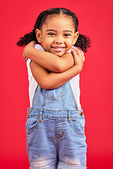 Image showing Portrait, hug and girl in studio for self love, sweet and loving gesture against red background with mockup. Face, child and happy, smile and toddler embracing, care and confident while isolated