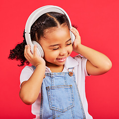 Image showing Happy, child and headphones for music, radio and fun podcast on isolated red background and dancing studio. Smile, little girl and kid listening to dance audio, song and streaming media on backdrop