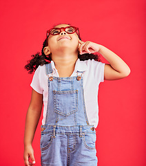 Image showing Looking up, thinking or child and fashion glasses on red background in vision, optician or eyesight sales deal. Smile, happy or little girl and optometry frames, ideas or decision choice of promotion