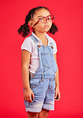 Image showing Portrait, glasses and bored with a black girl on a red background in studio for vision or eyesight. Kids, sad or unhappy with a female child wearing a new frame prescription spectacles for correction