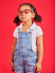 Image showing Portrait, glasses and unhappy with a black girl on a red background in studio for vision or eyesight. Kids, sad or bored with a female child wearing a new frame prescription spectacles for correction