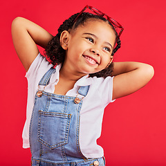 Image showing Little girl, happy and thinking in fashion pose, trendy or cool style clothes on isolated red background for kids branding. Smile, youth and child stretching arms in playful, funny and goofy posing