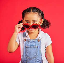 Image showing Child portrait, fashion and glasses on isolated red background in summer trend, holiday style and cool vacation. Smile, happy and kid with sunglasses for eyes healthcare, wellness and sun protection