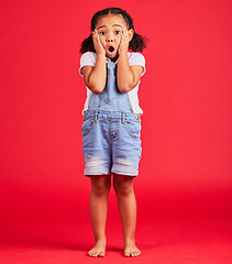 Image showing Child portrait, shocked or hands on face by isolated red background in kids gossip, bad news or scary children story. Surprised, anxiety or scared girl and horror facial expression, wow or emoji look