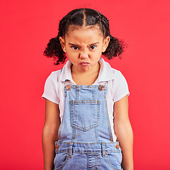 Image showing Child, portrait or angry face on isolated red background in emoji tantrum, behavior or stubborn studio problem. Mad, annoyed or frustrated little girl and sulking, grumpy or anger facial expression