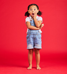 Image showing Little girl, portrait or shocked hand on face, isolated or red background and kids gossip, bad news or scary children story. Surprised, anxiety or scared kid in horror facial expression, wow or emoji