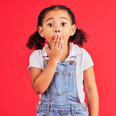 Image showing Shocked kid, portrait and hand on mouth in secret, oops and mistake facial expression on isolated red background. Child, little girl and surprised face in gossip, news or emoji at studio announcement
