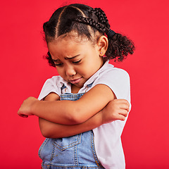 Image showing Kid, arms crossed or crying expression on isolated red background in depression, mental health or burnout. Upset, unhappy or little girl with sad, sulking or grumpy face in bullying crisis or anxiety