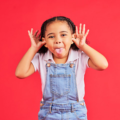 Image showing Child, portrait and tongue out on isolated red background in goofy, silly games and playful facial expression. Happy, kid and little girl with funny face in comic emoji, charades and studio activity