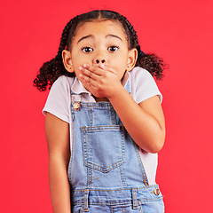 Image showing Shocked child, portrait and hand on mouth in secret, oops and mistake facial expression on isolated red background. Kid, little girl and surprised face in gossip, news or emoji at studio announcement