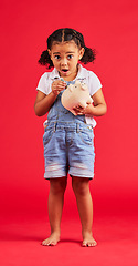 Image showing Surprised child, portrait and piggy bank for money deposit, kids savings or future investment on isolated red background. Shocked, girl and wow kid with cash box for finance growth or budget planning