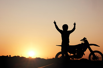 Image showing Motorcycle, silhouette and sunset with a sports man outdoor, arms raised in celebration for freedom with mockup. Sky, nature and motorbike with a male rider outside celebrating on a road trip