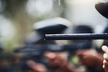 Image showing Paintball, gun or aim in rain, games arena or teamwork competition for sports, challenge or military training. Zoom, rifle or barrel of sniper shooting equipment for soldiers, army or battlefield war