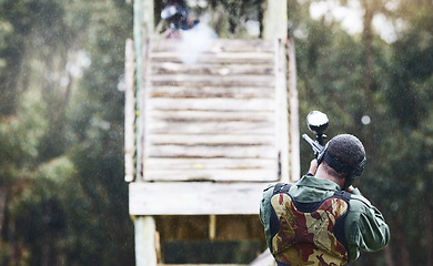 Image showing Paintball, gun or man with a target in shooting game with fast action on a fun battlefield on holiday. Military mission, aiming or player with weapons gear for war survival in an outdoor competition