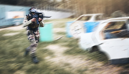 Image showing Paintball, gun or man running in a shooting game with fast action on a fun battlefield on holiday. Military mission, fitness or player with speed, weapons gear for survival in an outdoor competition