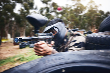 Image showing Paintball, gun or man playing a shooting game with fast action on a fun battlefield on holiday. Military mission, fitness or player aiming with weapons gear for war survival in an outdoor competition