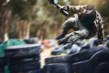 Image showing Fast, moving and man playing paintball with action, military clothes and running during a game in Australia. War, sport and person with blurred motion during a fun, playful and outdoor competition