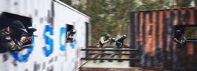 Image showing Paintball, gun or people running in a shooting game with fast action on a fun battlefield on holiday. Men on mission, war or players with military weapons gear for survival in an outdoor competition