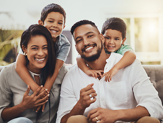 Image showing Mother, father and children hug for family portrait with smile relaxing together for holiday or weekend at home. Happy mom, dad and kids smiling for fun hug, love or care in relax on living room sofa