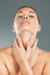 Image showing Woman, beauty and skincare holding neck in satisfaction for cosmetic treatment against grey studio background. Portrait of beautiful female touching soft, smooth or perfect skin for healthy wellness