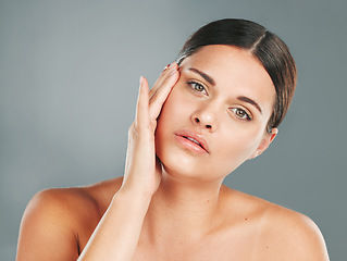 Image showing Beauty, portrait and woman touching face in studio for skincare, wellness and facial cosmetics. Young female model, aesthetic makeup and dermatology from healthy shine, natural glow and salon results