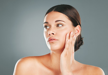 Image showing Beauty, skincare and woman touching face in studio for wellness, clean facial and cosmetics. Young female model, aesthetic makeup and dermatology from healthy shine, natural glow and salon results