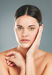 Image showing Beauty, portrait and woman hands touching face in studio for wellness, luxury facial and cosmetics. Young female model, aesthetic skincare and dermatology from healthy shine, glow and salon results