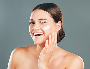 Image showing Skincare cream, beauty portrait and woman face with happiness from sunscreen and self care. Wellness, spa and smile of model with collagen lotion with studio background and dermatology treatment