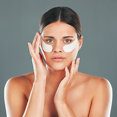 Image showing Skincare, eyes patch and portrait of woman, beauty and dermatology on studio background. Female model, face and eye care gel for dark circles, body cosmetics and wellness of facial collagen treatment