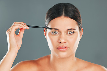 Image showing Eyebrow skincare, brush and portrait of woman in studio for headshot, beauty transformation and cosmetics. Face, makeup and brushing brows with facial tool, model and hair on eyes for clean aesthetic