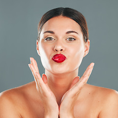 Image showing Portrait, woman lips with lipstick and kiss face, red cosmetics and playful pout isolated on studio background. Makeup, beauty and skincare with cosmetic care, wellness and glow, facial and fun