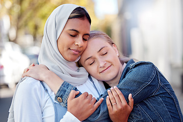 Image showing Friends, women and hug outdoor, peace and reunion in street together, happiness and calm. Females with trust, ladies or embrace in city, achievement and wellness with quality time, summer and freedom