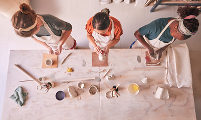 Image showing Pottery class, ceramic workshop or people design sculpture mold, clay manufacturing or art product. Diversity, retail store or top view of startup small business owner, artist or studio women molding