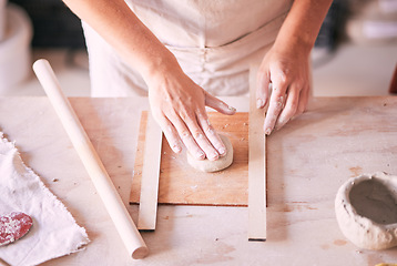 Image showing Creative, pottery and design with hands of woman in workshop studio for mold, ceramics and art. Clay, sculpture and manufacturing with girl artisan on table for crafting, handmade and hobby