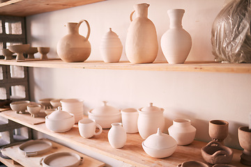 Image showing Ceramics, dishes and pottery on shelf in studio, creative store and manufacturing startup. Clay products, background and shelves in workshop, small business and retail craft shop of stock production