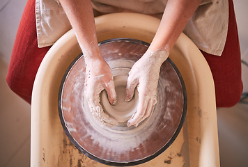 Image showing Creative, pottery and design with hands of woman in workshop studio for molding, ceramics and art. Clay, sculpture and manufacturing with girl artisan and wheel for crafting, handmade and hobby