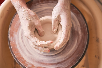 Image showing Creative, pottery and design with hands of woman in workshop studio for molding, ceramics and art. Clay, sculpture and manufacturing with girl artisan on wheel for crafting, handmade and hobby