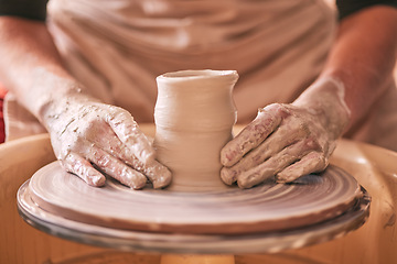 Image showing Hands, pottery and clay mold on table for creative art design, product or sculpture for startup workshop. Hand of crafty artist molding ceramic material in creation, shape or tool with spinning wheel