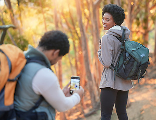 Image showing Forest, phone photography or black couple hiking in nature for exercise, workout or training on holiday. Travel, pictures or African partners trekking or walking to hill on a fun outdoor adventure